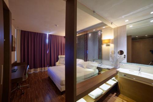 a hotel room with a bed and a sink at San Paolo Hotel in Montegiorgio