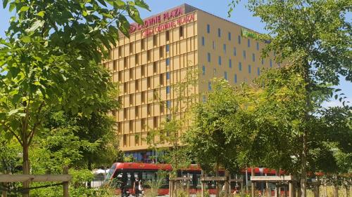 a building with a red bus in front of it at Crowne Plaza - Nice - Grand Arenas by IHG in Nice