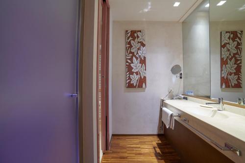 a bathroom with a sink and a mirror at San Paolo Hotel in Montegiorgio