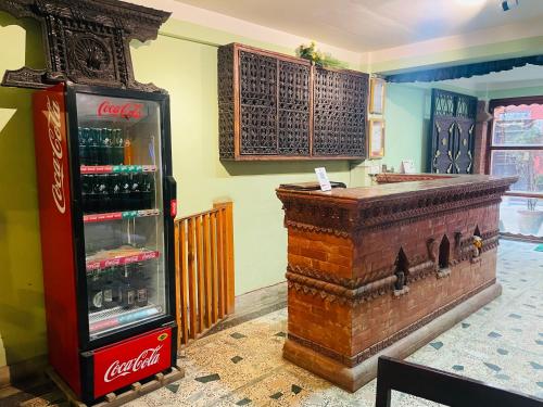 a coca cola machine and a bar in a room at Hotel Bhaktapur Inn in Bhaktapur
