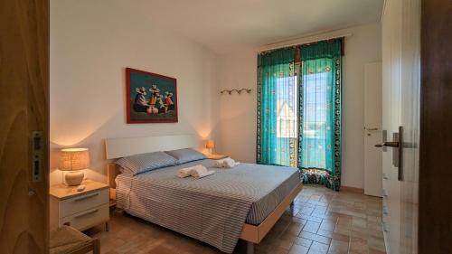 a bedroom with a bed and a large window at Marzamemi, Sul Livello del MARE, GOLD in Marzamemi