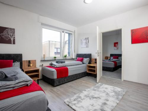 a bedroom with two beds and a living room at SR24 - Stilvolle Wohnung 3 in Herten in Herten