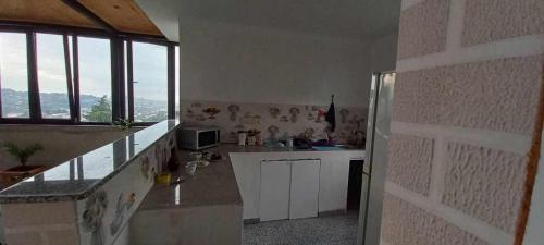 a kitchen with a sink and a refrigerator at ლამაზი სახლი და სასიამოვნო გარემო სტუმრებისთვის in Batumi