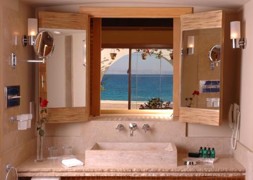 a bathroom with a sink and a window with the ocean at Retac Qunay Dahab Resort & SPA in Dahab