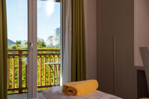 a room with a bed and a balcony with a view at Maso Agritur Santa Lucia in Dro