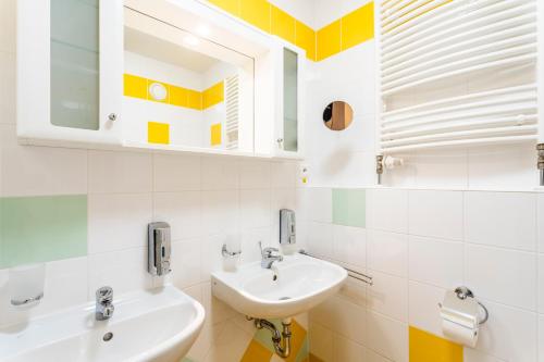 a bathroom with two sinks and a mirror at Complex Curie in Jáchymov