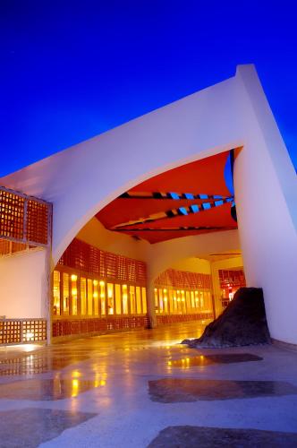 a large building with an arch at night at Retac Qunay Dahab Resort & SPA in Dahab