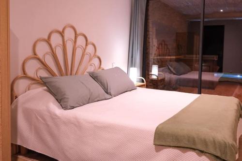 a bedroom with a large bed with a large headboard at Maison d'hôtes Les Oliviers in Cazouls-lès-Béziers