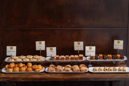 a display of different types of donuts and pastries at Parador de Cangas de Onís in Villanueva de Cangas de Onís