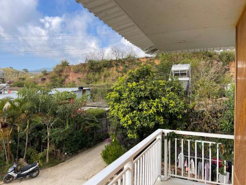 a scooter parked on a porch of a house at Chú Ba Farmstay - cách Đà Lạt 40km in Ấp Phú Thuận