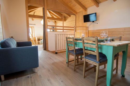 a dining room with a blue table and chairs at Begale - Rifugio Urbano in Rotzo