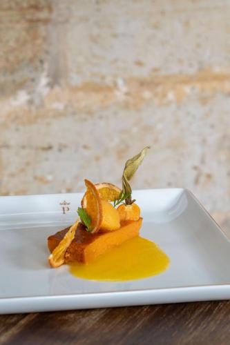 a white plate with a piece of food on a table at Parador de Cangas de Onís in Villanueva de Cangas de Onís