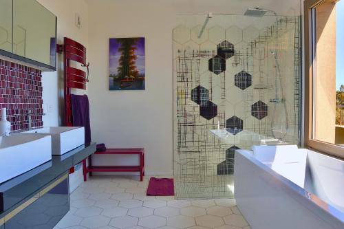 a bathroom with two sinks and a glass shower at Villa Leana Villata in Sainte-Lucie de Porto-Vecchio