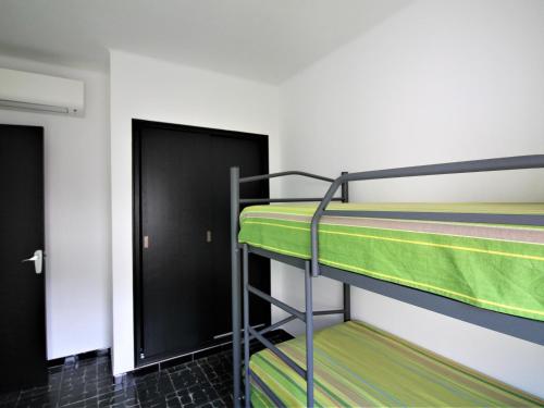 a bunk bed room with two bunk beds and a door at Apartamento Roses, 2 dormitorios, 6 personas - ES-258-76 in Roses