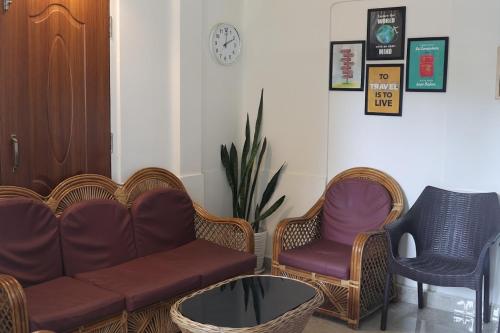 a living room with a couch and chairs and a table at Lamin Guest House in Dawki