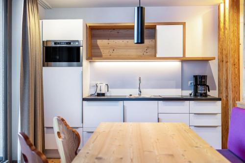 a kitchen with a wooden table in a room at Stoana Apt 1-1 in San Giacomo