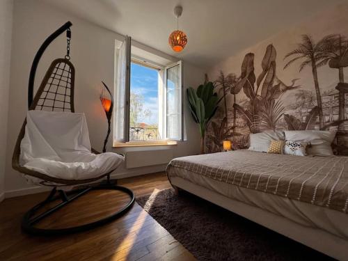 a bedroom with a bed with a chair and a window at Grand F2 proche du centre ville. in Châlons-en-Champagne
