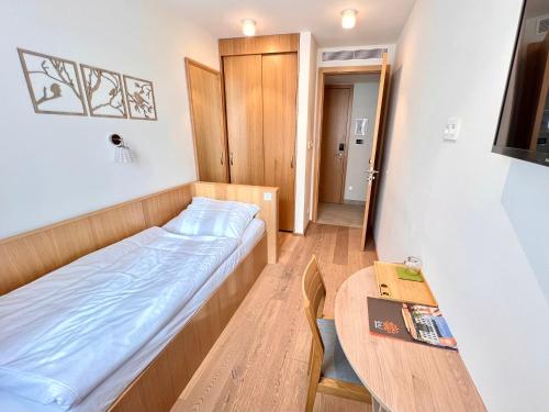 a small room with a bed and a table at RAJ zdravia in Bratislava