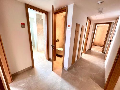 a hallway with a bathroom with a toilet and a mirror at RAJ zdravia in Bratislava