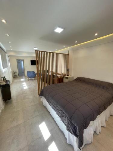 a bedroom with a large bed in a room at Patagonia House - Peña in Puerto Madryn
