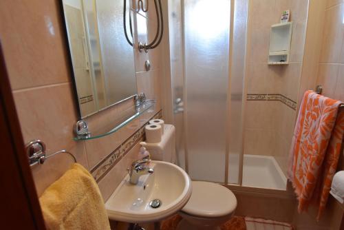 a bathroom with a sink and a toilet and a shower at Villa DELFINA 2 in Podgora