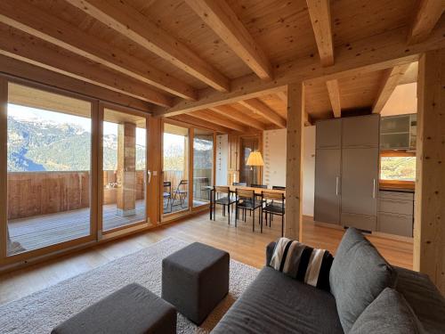 a living room with a couch and a table at Chalet Roossi 4 in Wengen