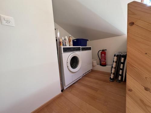 a laundry room with a washing machine in a attic at Chalet Roossi 4 in Wengen