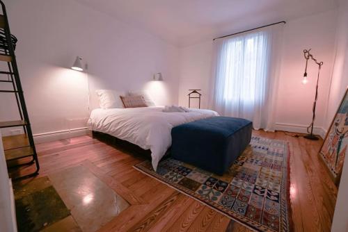 a bedroom with a bed and a large window at Maison de Champagne F.Barbier ! in Avize