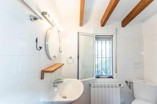 a bathroom with a sink and a toilet at Cortijo Bellavista in Cómpeta