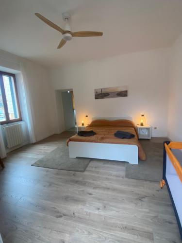 a bedroom with a bed and a ceiling fan at A Casa di Nonna Anna in Porto Azzurro