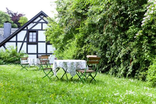a group of tables and chairs in the grass at Romantik Hotel Alte Vogtei in Hamm