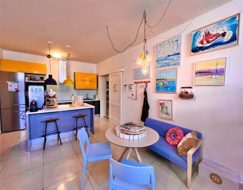 a living room with a blue couch and a table at Apartments Villa Lukas in Cavtat