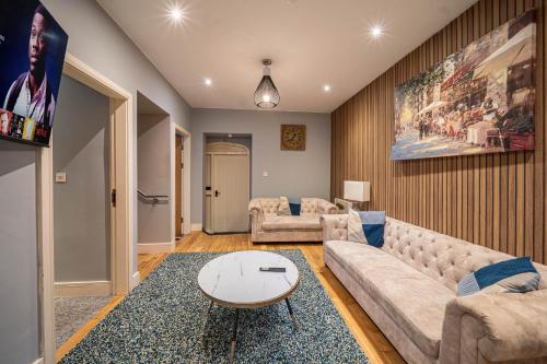 a living room with a couch and a table at Kelham Apartments Sheffield in Sheffield