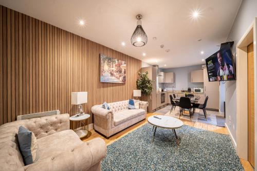 a living room with a couch and a table at Kelham Apartments Sheffield in Sheffield