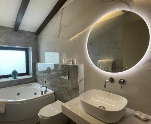 a bathroom with a sink toilet and a mirror at Hotel Centrum in Catania