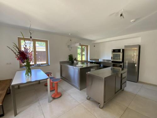 a kitchen with a vase of flowers on a table at Gruppenhaus Baiersbronn LUG INS TAL in Baiersbronn