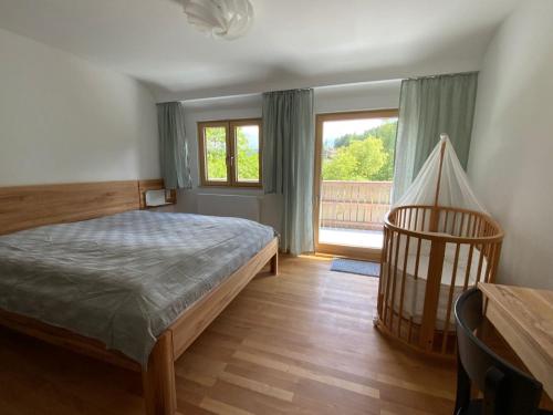 a bedroom with a bed and a large window at Gruppenhaus Baiersbronn LUG INS TAL in Baiersbronn