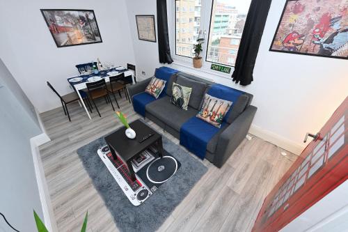 a living room with a couch and a table at SUPERB 4 BEDROOM FLAT in THE HEART OF CAMDEN TOWN in London