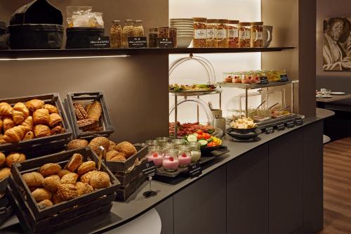 a buffet line with pastries and other food items at Hotel St. Annen in Hamburg