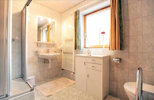 a bathroom with a sink and a toilet and a shower at Bergkristall in Brand