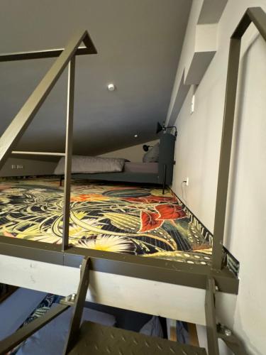 a bunk bed in a small room with a staircase at Pebbles Suiten by RiNG in Regensburg