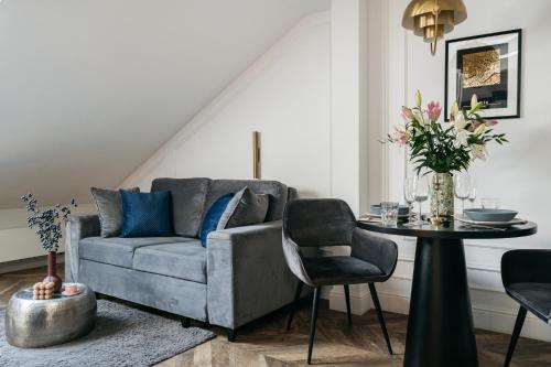 a living room with a couch and a table at Central Palace - LoftAffair Collection in Kraków