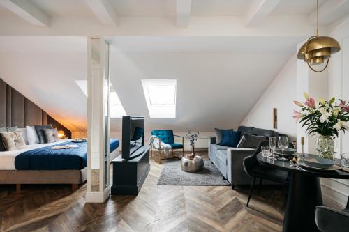 a bedroom with a bed and a living room at Central Palace - LoftAffair Collection in Kraków