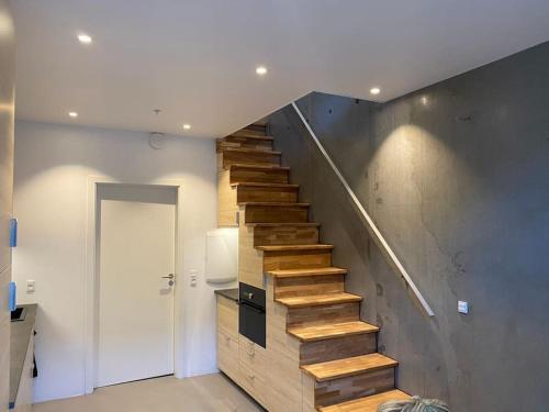 a staircase in a house with wooden steps at Beach house apartment in New York style in Aarhus