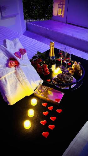 a table with hearts on it with wine glasses at Suite in the City avec JACUZZI PRIVATIF - Hyper Centre in Montpellier