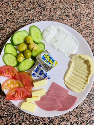 a plate of food with vegetables and cheese and crackers at Shakria Bedouin Life Camp in Wadi Rum