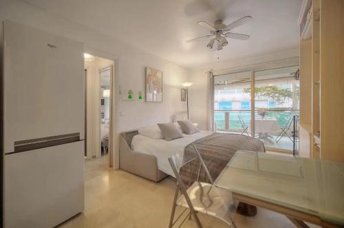 a bedroom with a bed and a ceiling fan at One Bed Apt in the center of Cannes - 2198 in Cannes