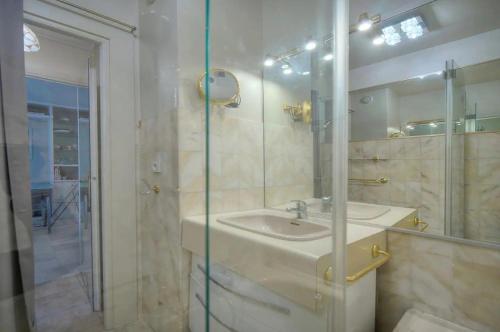 a bathroom with a sink and a glass shower at One Bed Apt in the center of Cannes - 2198 in Cannes