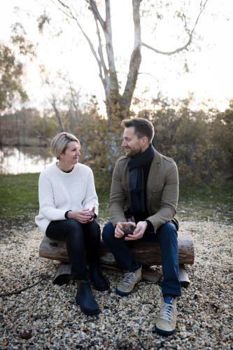 a man and a woman sitting on a bench at Goldfield Glamping in Clydesdale