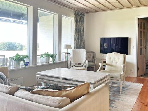 ein Wohnzimmer mit einem Sofa und einem Tisch in der Unterkunft Country house with sea view near Hovs Hallar in Båstad